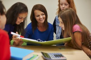 Teacher showing students interesting book